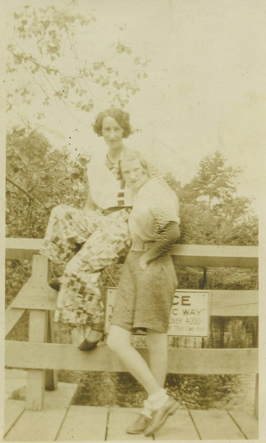 Two unidentified women on a railing