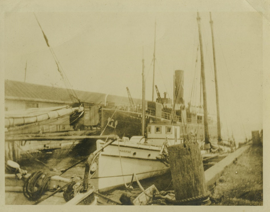 Unidentified boats at a wharf