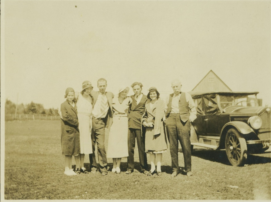 Family group beside a car