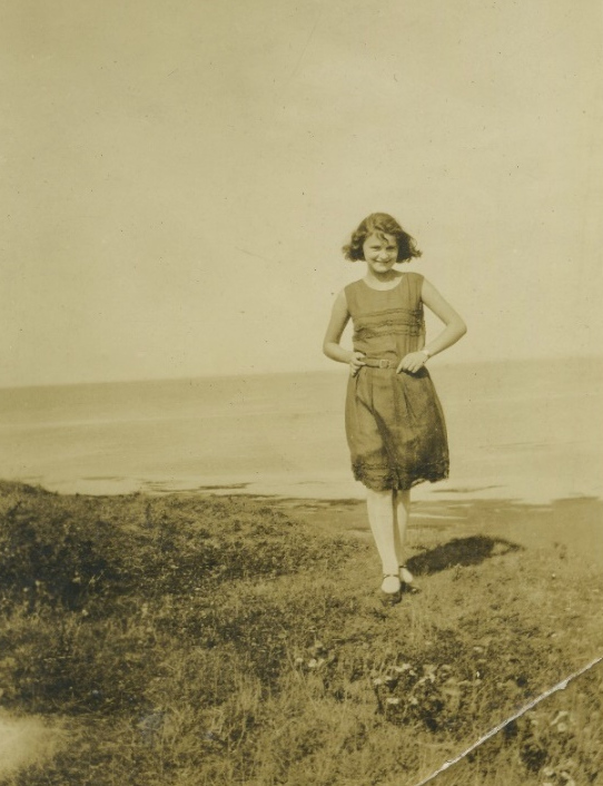 Unidentified woman on a grassy shore